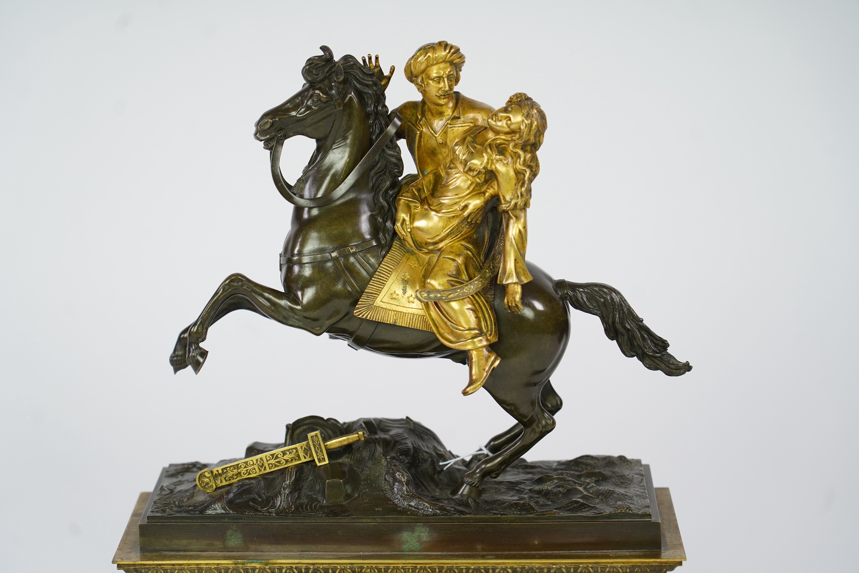 A late nineteenth century brass and bronze cased clock, mounted with a part gilt bronze of a mounted Turkish soldier and woman